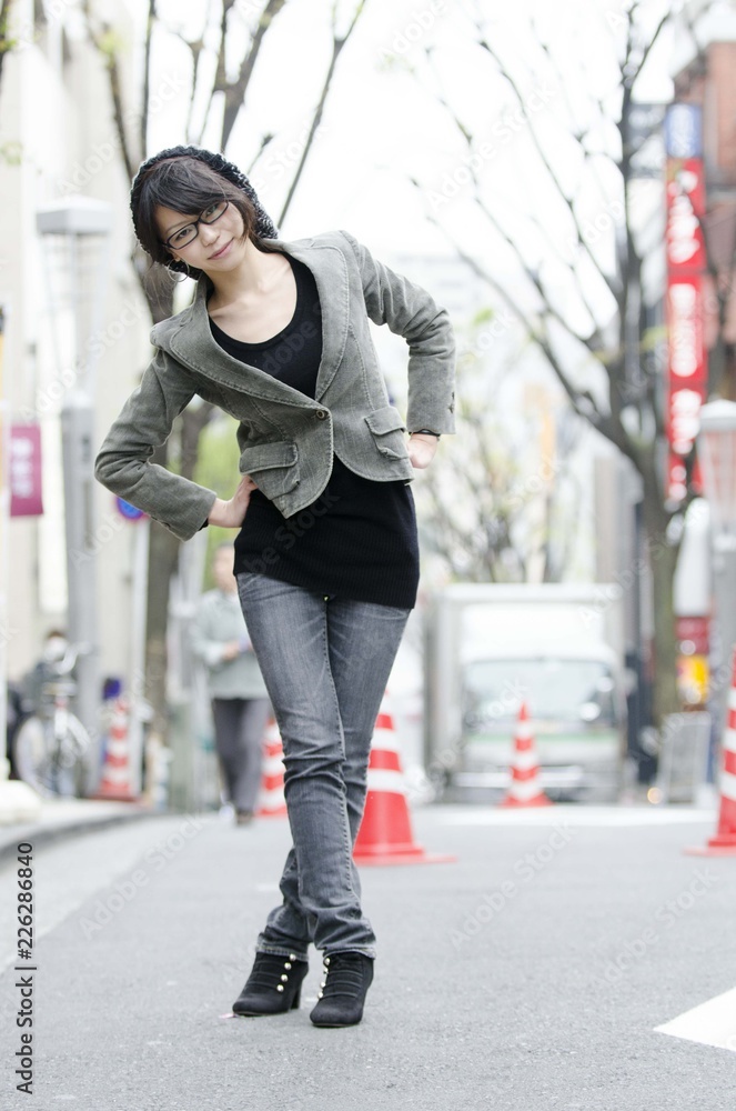 Japanese Girl poses on the street in Toranomon, Japan. Toranomon is a business district in Tokyo. Japanese Girl poses on the street in Toranomon, Japan. Toranomon is a business district in Tokyo.