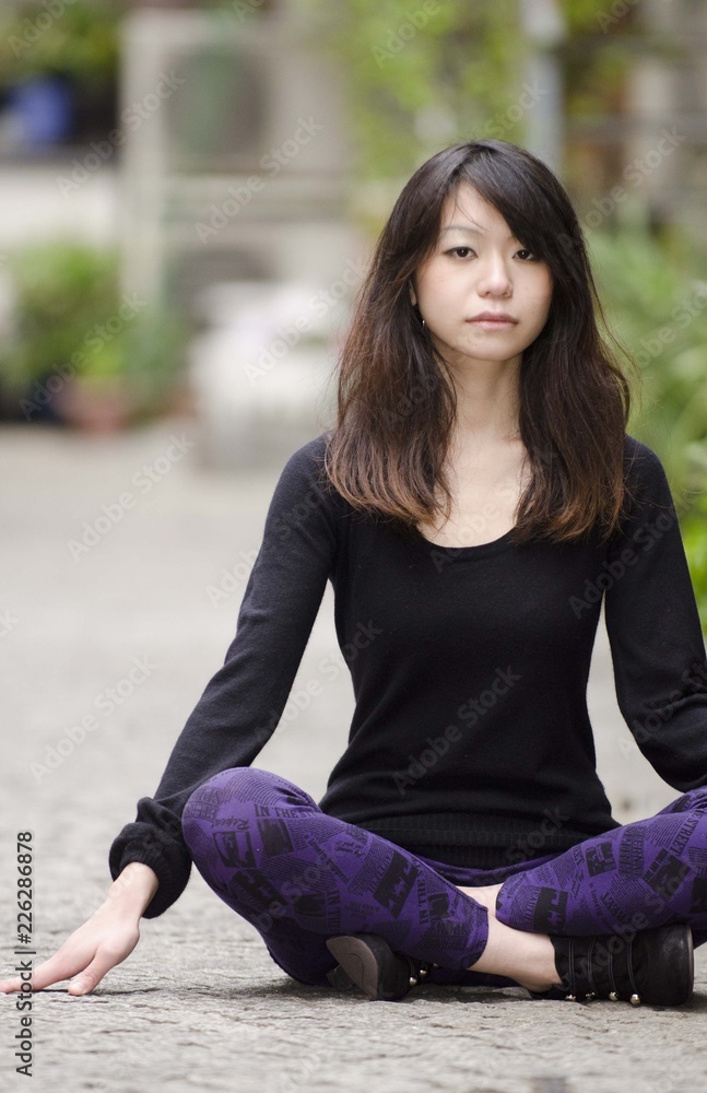 Japanese Girl poses on the street in Toranomon, Japan. Toranomon is a business district in Tokyo. Japanese Girl poses on the street in Toranomon, Japan. Toranomon is a business district in Tokyo.