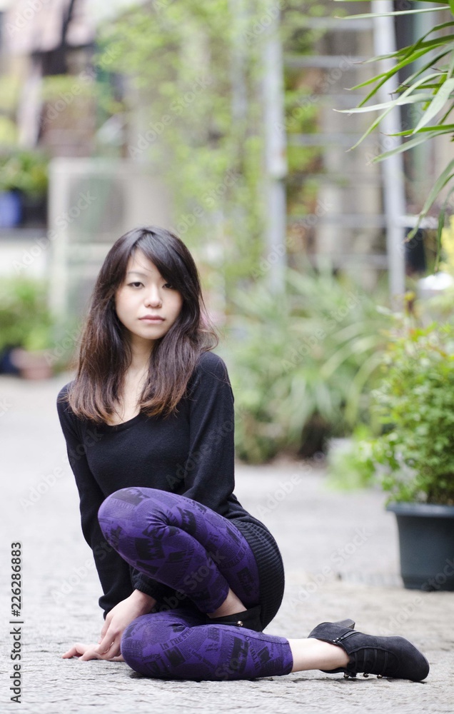 Japanese Girl poses on the street in Toranomon, Japan. Toranomon is a business district in Tokyo. Japanese Girl poses on the street in Toranomon, Japan. Toranomon is a business district in Tokyo.