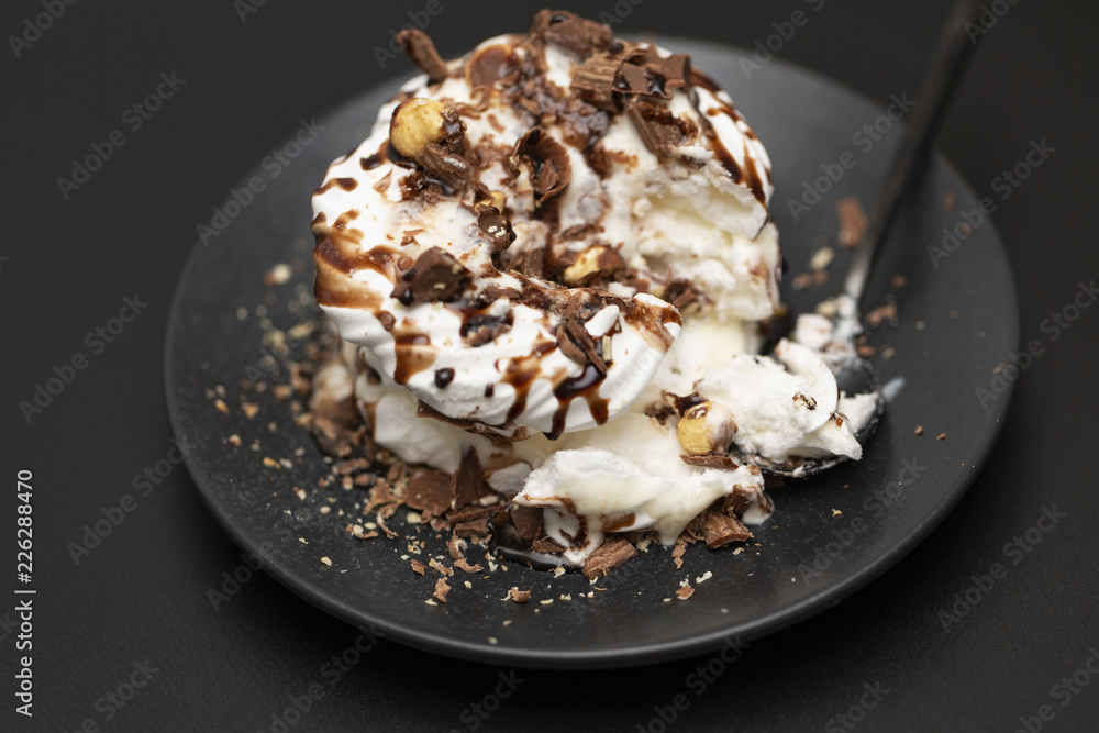 Meringue dessert with chocolate sauce, chocolate, nuts and cream. Meringue dessert with chocolate sauce, chocolate, nuts and cream.