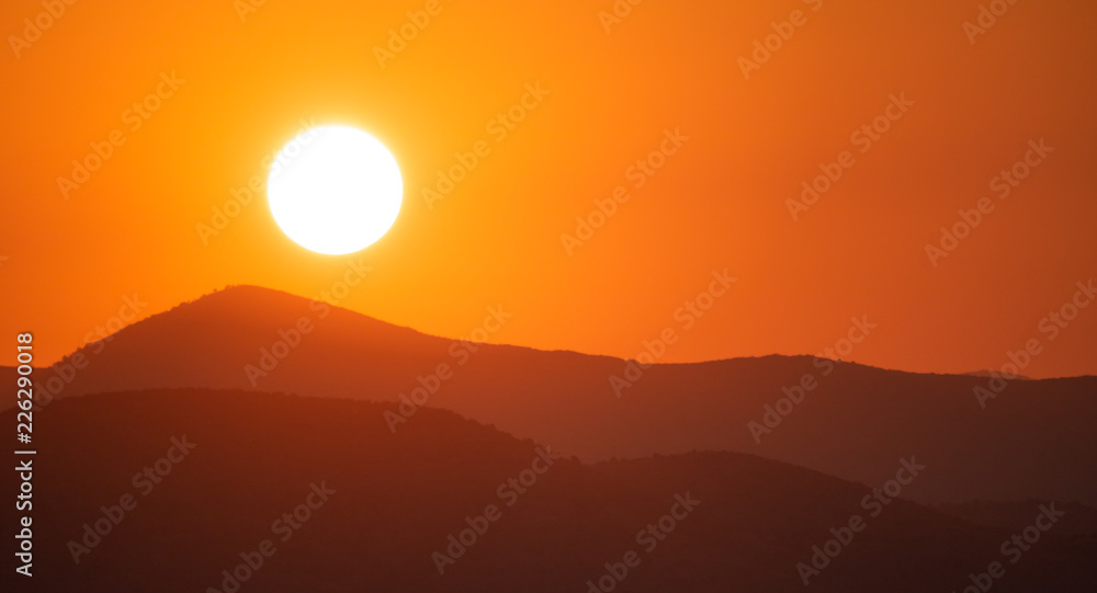 Sunrise, sunset over mountains silhouette. Colorful sky background, space, panoramic view.
