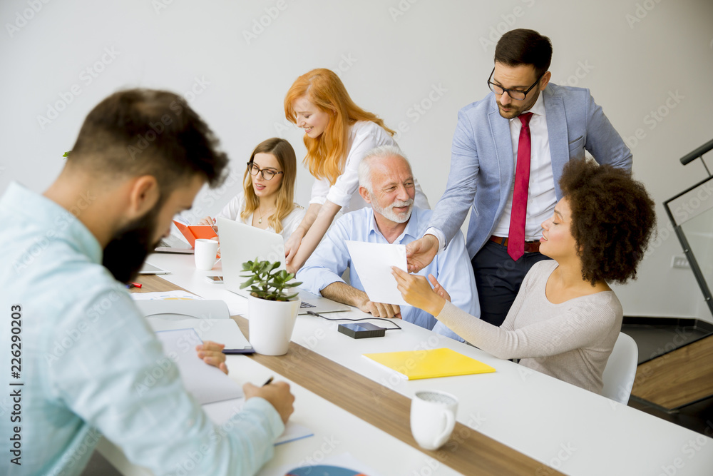 Joyful multiracial business team at work in modern office Joyful multiracial business team at work in modern office