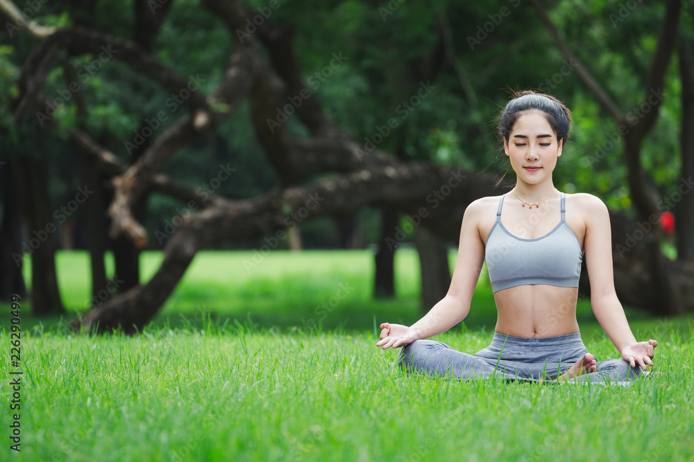 Fitness asian woman doing yoga in park Fitness asian woman doing yoga in park
