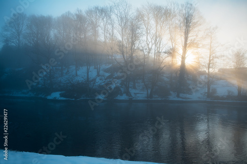 A beautiful winter landscape scenery where the sun rises over the hill