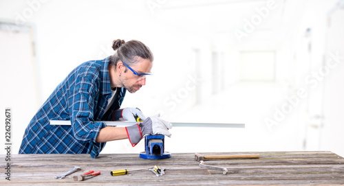 worker in blue  shirt working with metal