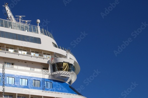 Ship's bridge of a cruise liner against blue sky - side view