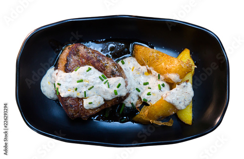 Top view of veal sirloin with potato and mushroom sauce