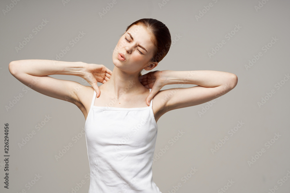 woman holds her hands on her shoulders