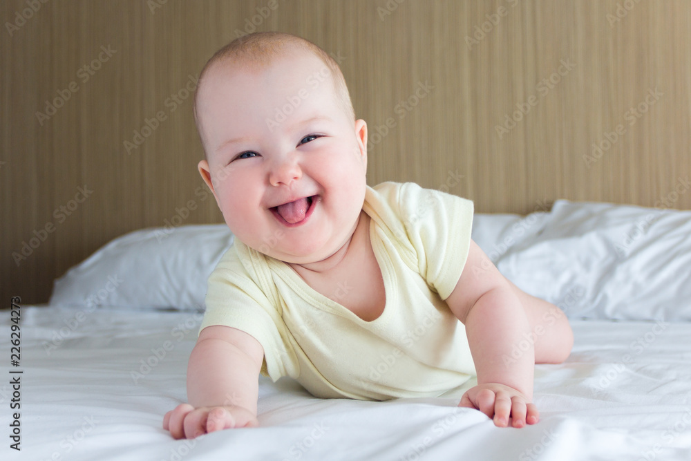 portrait of funny little baby girl lying on the bed portrait of funny little baby girl lying on the bed
