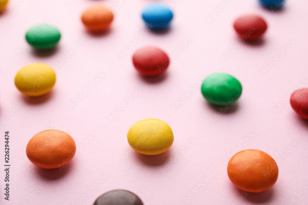 Tasty glazed candies on color background, closeup Tasty glazed candies on color background, closeup
