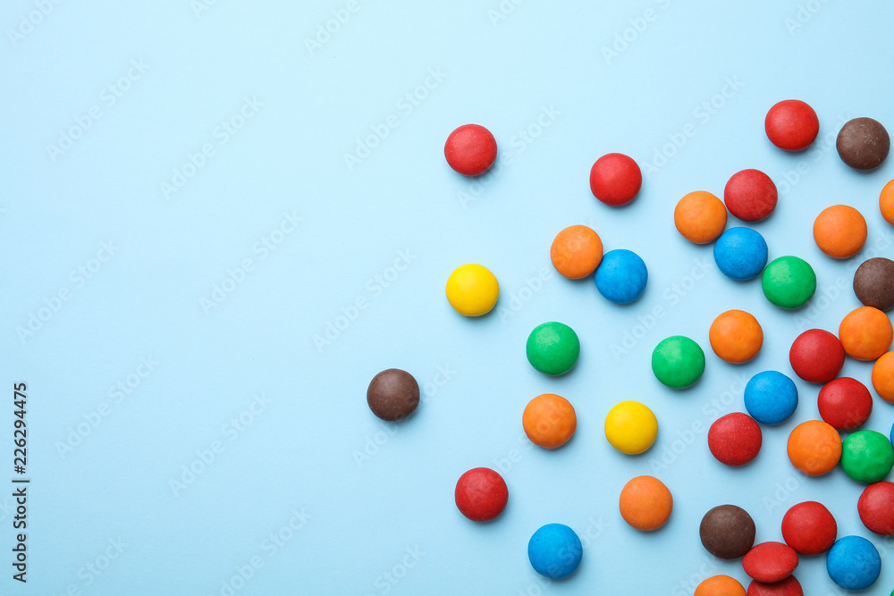 Tasty glazed candies and space for text on color background, top view Tasty glazed candies and space for text on color background, top view