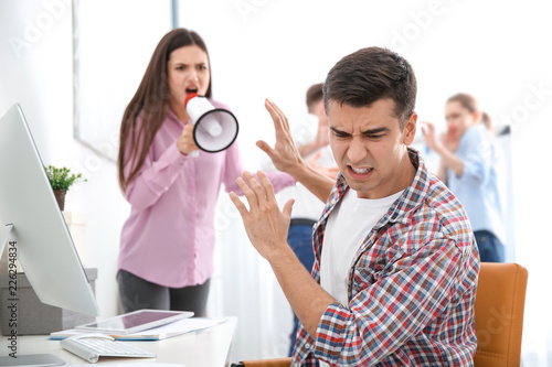 Angry boss with megaphone s...