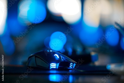 Tableau sur toile Gaming blue illuminated mouse isolated in dark