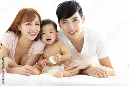 happy young father and mother  with baby