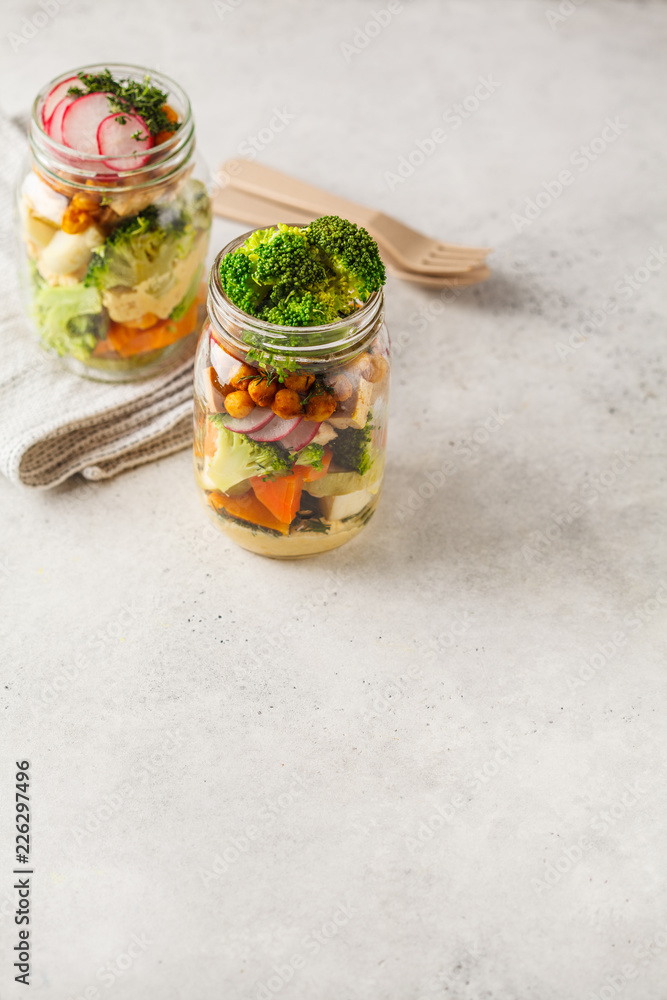 Healthy Homemade Mason Jar Salad with baked vegetables, hummus, tofu and chickpeas, copy space. Healthy Homemade Mason Jar Salad with baked vegetables, hummus, tofu and chickpeas, copy space.