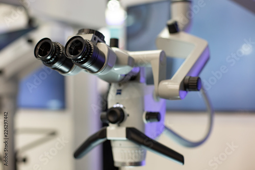 Dental microscope on the background of modern dentistry. Medical equipment. Dental operating microscope with rotary double binocular.