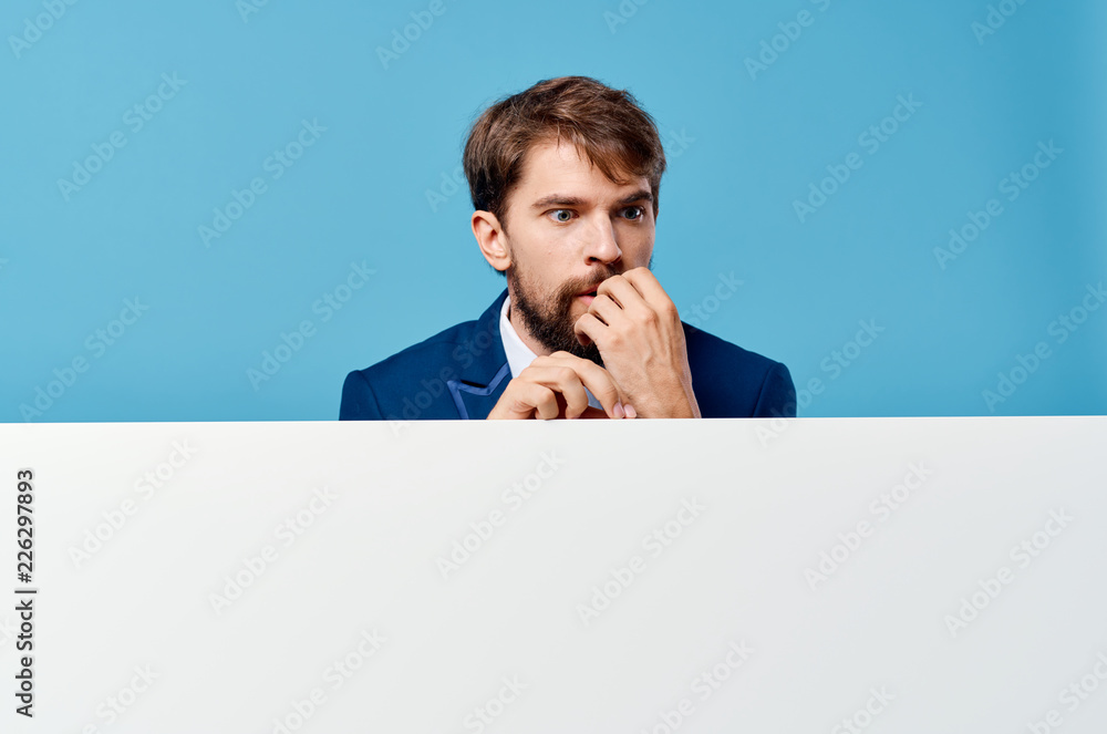 man holds in his hand a white sheet of paper puzzled look man holds in his hand a white sheet of paper puzzled look