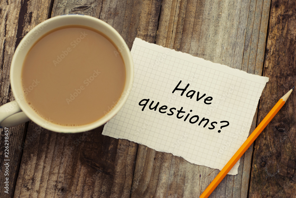 Have questions Inscription on white blank paper with pencil and cup of coffee. Rustic wooden background. Have questions Inscription on white blank paper with pencil and cup of coffee. Rustic wooden background.
