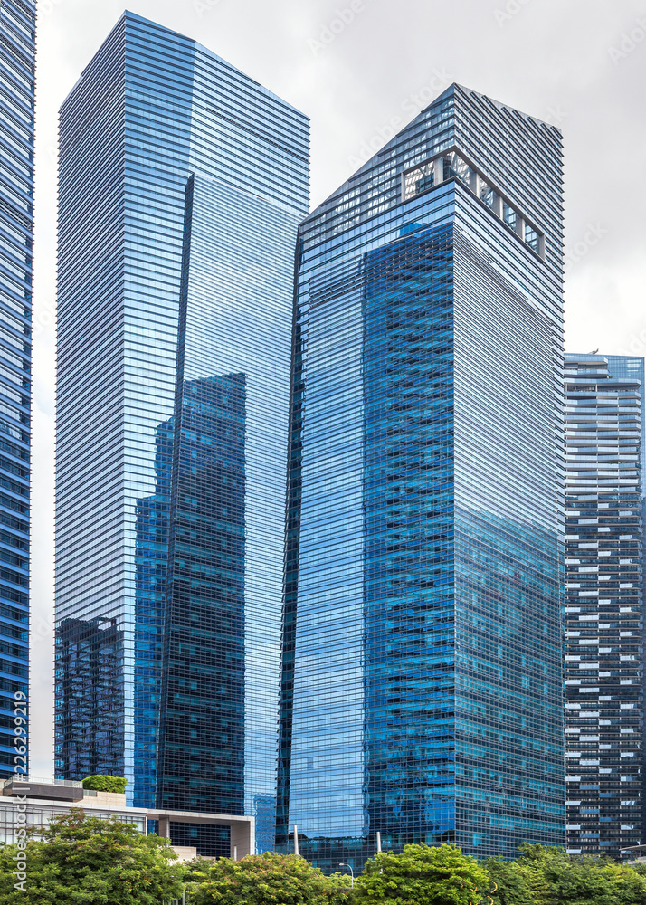 Glass high skyscrapers in the center of Singapore on the waterfront. Glass high skyscrapers in the center of Singapore on the waterfront.