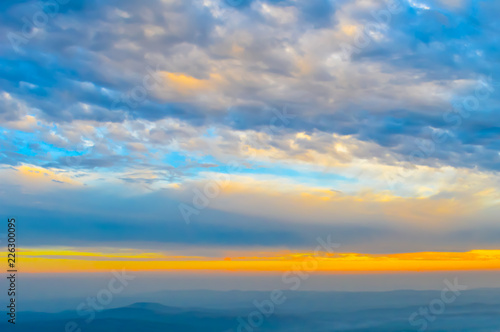 Vibrant color cloud scape on a dramatic sky. Image was captured on a sunny summer day in sunset time. Outdoor travel photography. (Hill station of Darjeeling, West Bengal, India)