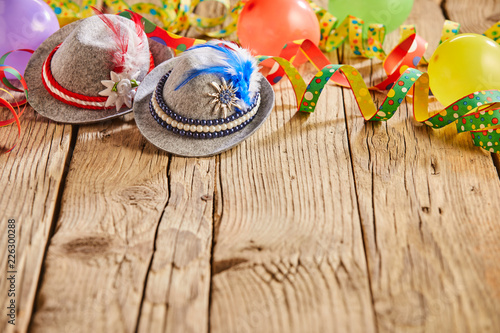 Hats and balloons sitting on rustic wooden table photo