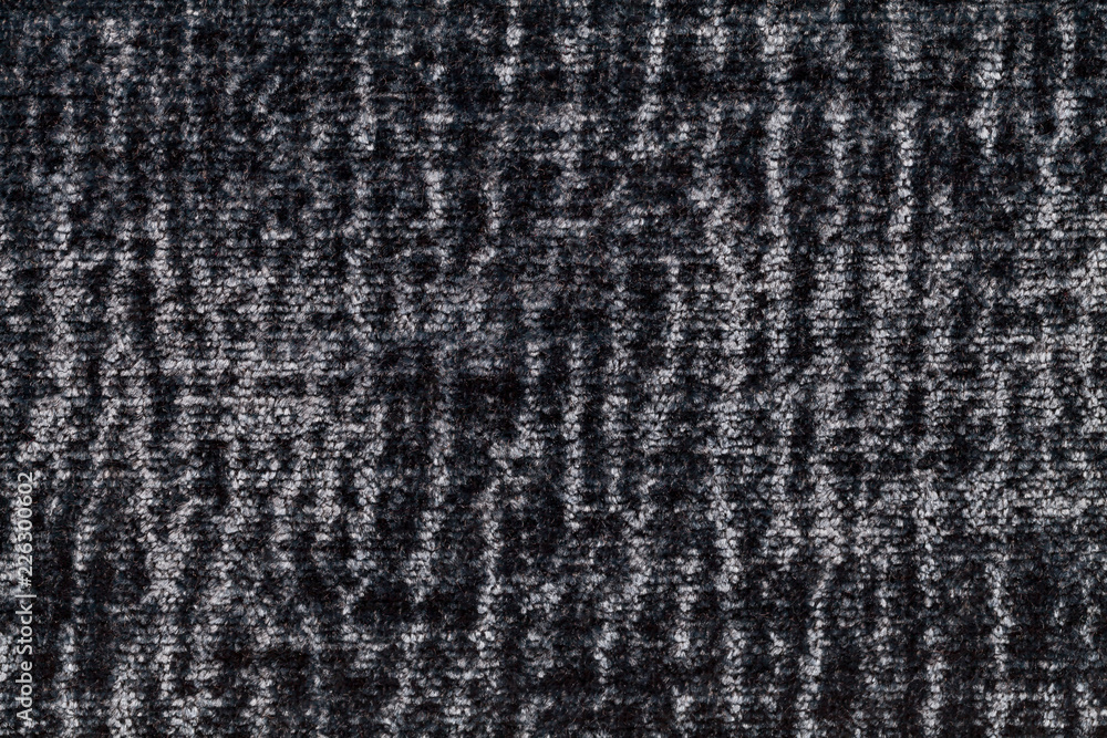 Black and gray fluffy background of soft, fleecy cloth. Texture of plush furry textile, closeup. Black and gray fluffy background of soft, fleecy cloth. Texture of plush furry textile, closeup.