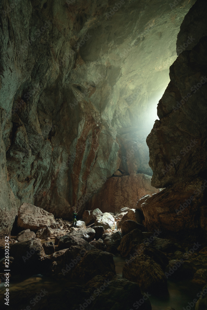 Mysterious cave, Tourist in the Occidental Carpathians, Radesei Cave, Apuseni Mountains, Romania