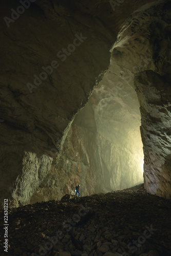 Mysterious cave, Tourist in the Occidental Carpathians, Radesei Cave, Apuseni Mountains, Romania photo