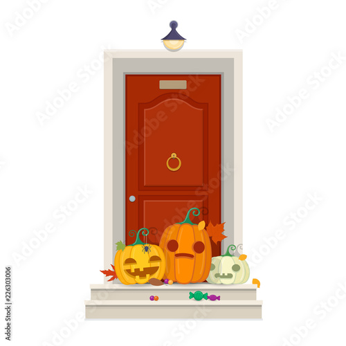 Front door with Halloween pumpkins and sweets in front of entrance