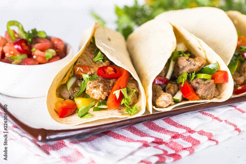 Mexican pork tacos with vegetables and salsa. Mexican pork tacos with vegetables and salsa.