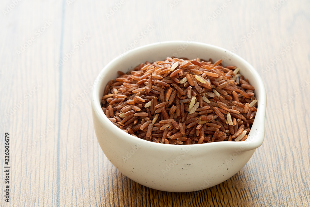 brown rice for healthy white bowl on wood background brown rice for healthy white bowl on wood background
