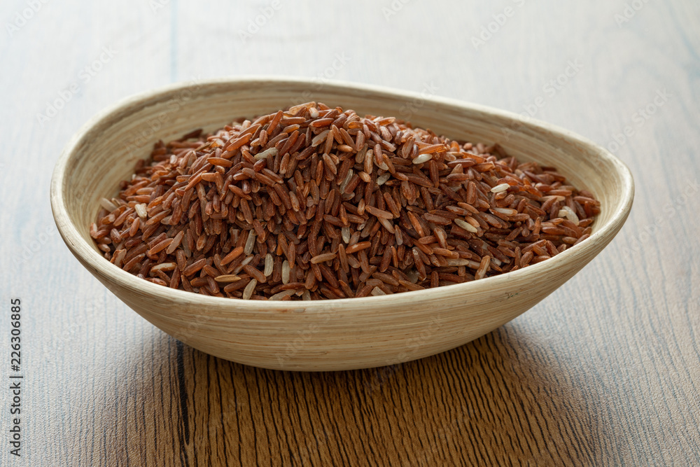 brown rice for healthy wood bowl on wood background