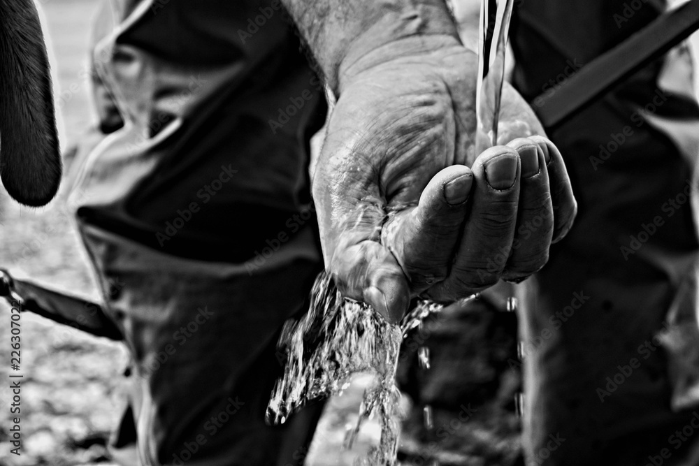 Water licking over man hand/ Closeup and macro details 