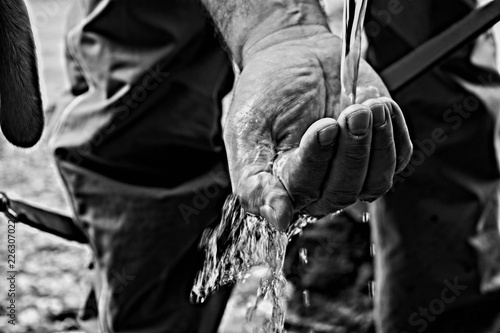 Water licking over man hand/ Closeup and macro details 