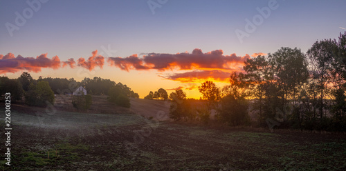 Fototapeta Naklejka Na Ścianę i Meble -  beautiful, dramatic sky over an autumn field enveloped in the morning mists-Poland, Drawskie Lakeland