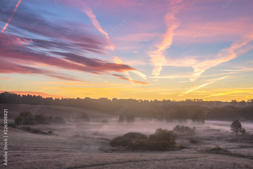 Fototapeta premium beautiful, multicolored dawn above the panorama of fields and meadows. landscape picture resembling Italian Tuscany. Autumn-Poland, Drawsko Lake District