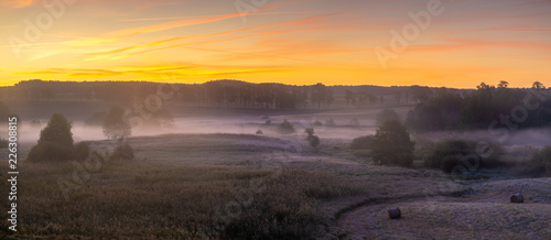 Fototapeta Naklejka Na Ścianę i Meble -  beautiful, multicolored dawn above the panorama of fields and meadows. landscape picture resembling Italian Tuscany. Autumn-Poland, Drawsko Lake District