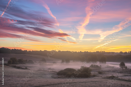 Fototapeta Naklejka Na Ścianę i Meble -  beautiful, multicolored dawn above the panorama of fields and meadows. landscape picture resembling Italian Tuscany. Autumn-Poland, Drawsko Lake District