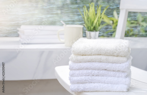 White towels on white beach chair with copy space on blurred blue sea background
