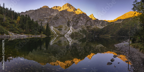 Fototapeta Naklejka Na Ścianę i Meble -  Panorama of a mountain lake during sunrise - Morskie Oko, Tatra Mountains, Poland