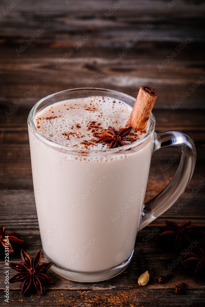 Homemade Chai Tea Latte with anise and cinnamon stick in glass mug Homemade Chai Tea Latte with anise and cinnamon stick in glass mug