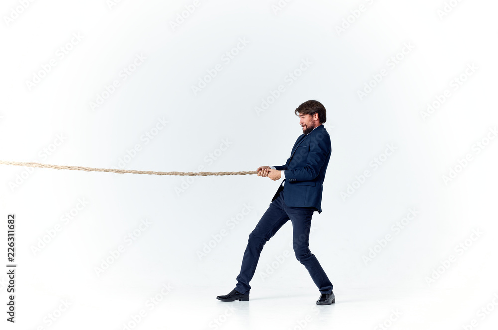 a man in a dark suit pulls the rope a man in a dark suit pulls the rope