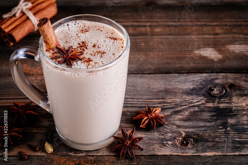 Photos Homemade Chai Tea Latte with anise and cinnamon stick in glass mug