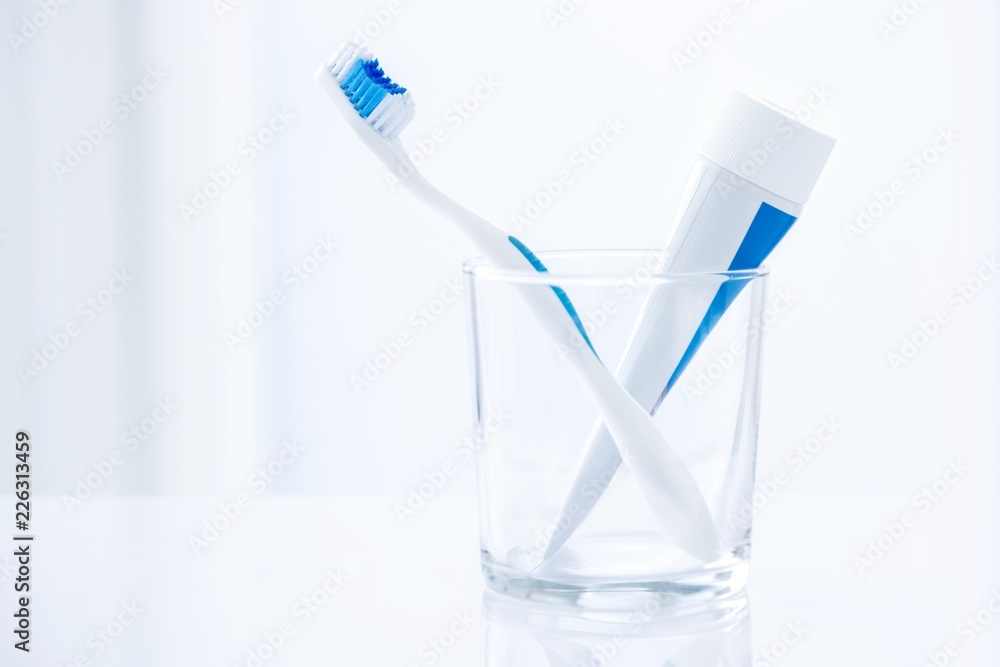 Toothbrush and toothpaste in glass Toothbrush and toothpaste in glass