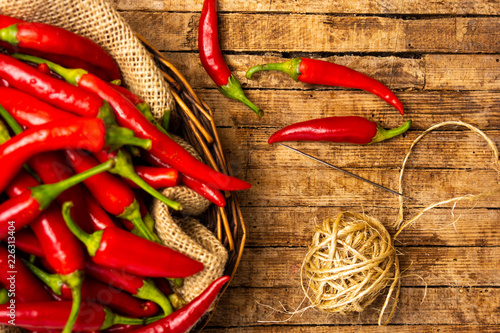 Thin red peppers with a needle and thread