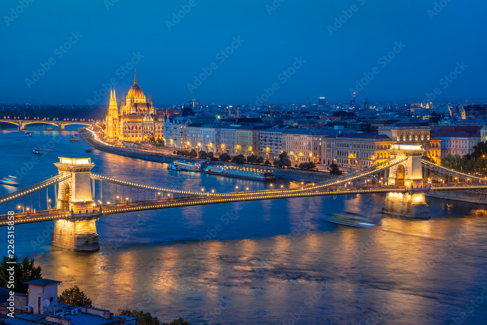 Aerial view of Budapest parliament and Chain bridge over Danube river at night, Hungary