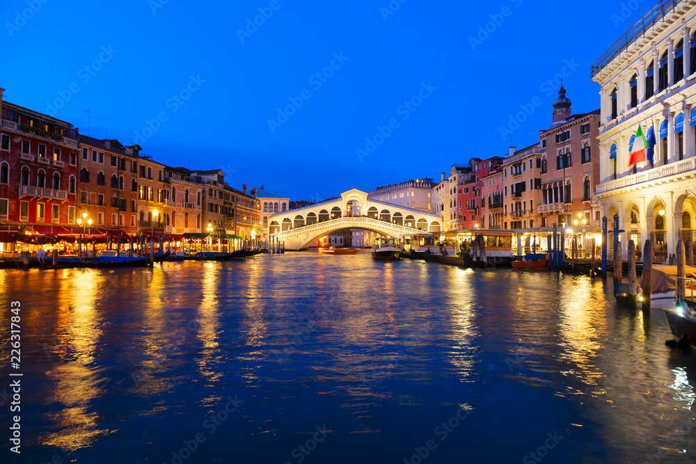 view of famouse Rialto bridge illuminated at night, Venice, Italy