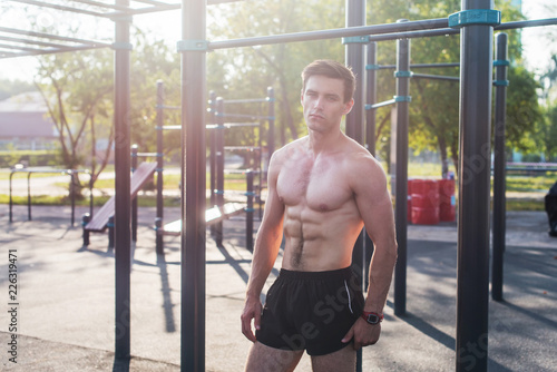 Tableau sur toile Muscular fitness male model posing shirtless demonstrating six packs abs
