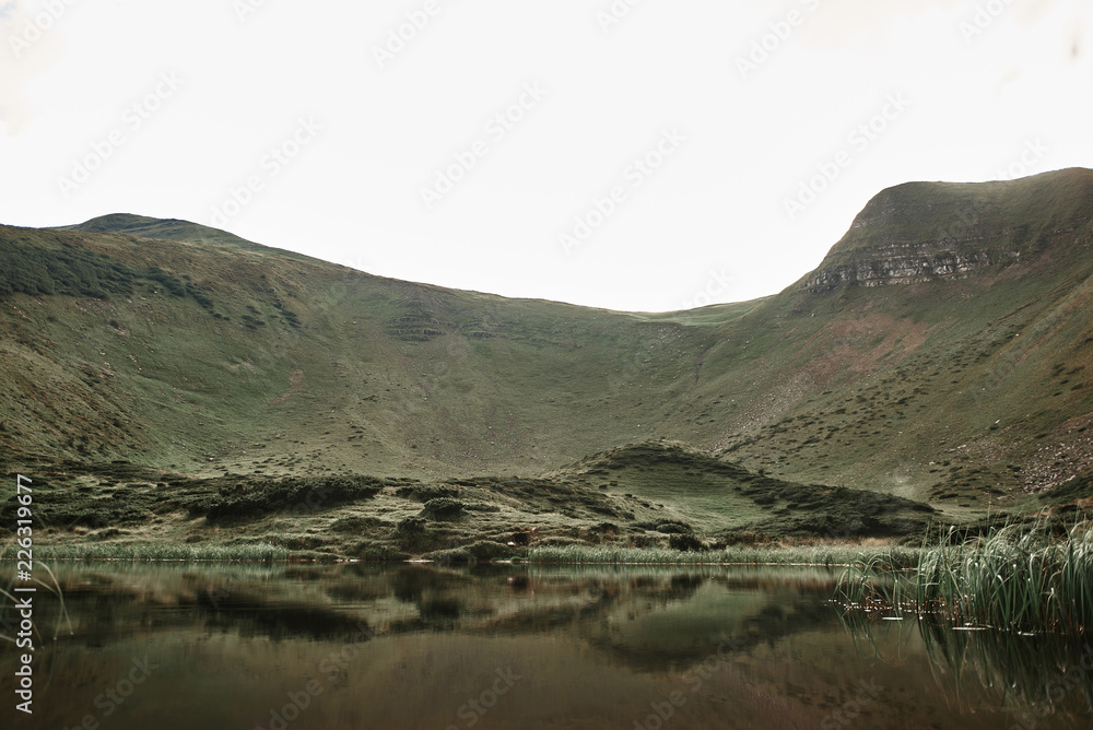 Mountain lake. Panoramic view of the beautiful green hills with little lake in the middle