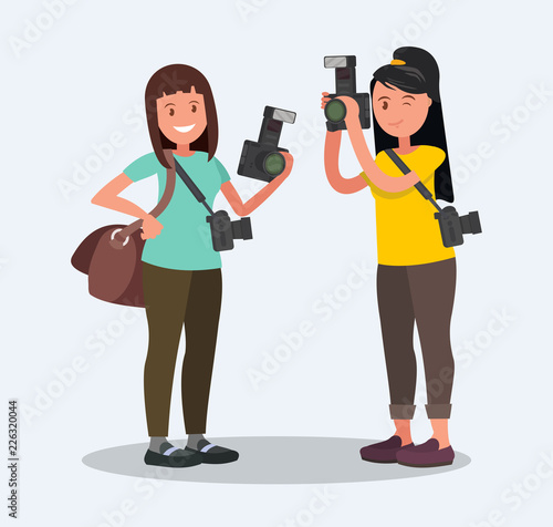Two female photographer with cameras on white background.